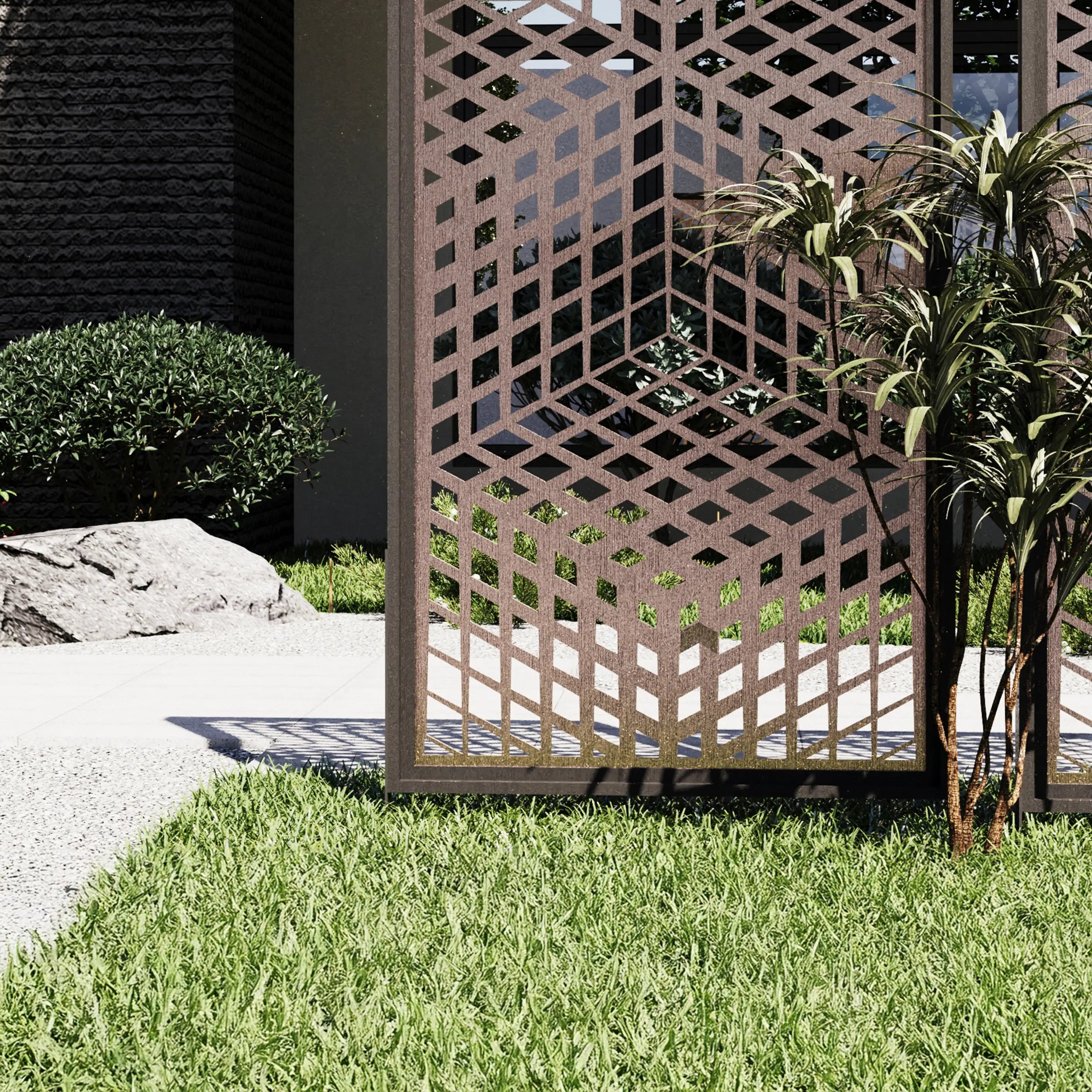 Decorative metal screen in a garden setting with plants and rocks.